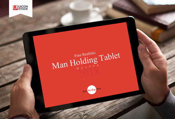 Free-Realistic-Man-Holding-Tablet-Mockup-2018