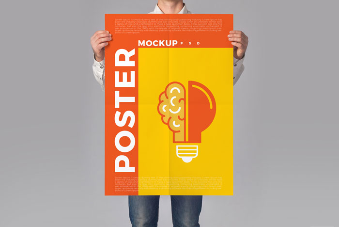 Man-Holding-Poster-Mockup-PSD-To-Showcase-Creative-Designs